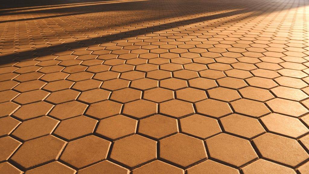 Hexagon Brown Cobblestone Pavement in vintage style with Golden Sunlight Reflection on Surface